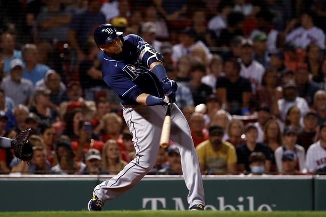 Tampa Bay Rays' Nelson Cruz hits a two-run home run against the Boston Red Sox during the third inning of a baseball game Tuesday, Sept. 7, 2021, at Fenway Park in Boston. (AP Photo/Winslow Townson)