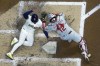Milwaukee Brewers' Eduardo Escobar scores safely past Philadelphia Phillies catcher Rafael Marchan during the third inning of a baseball game Tuesday, Sept. 7, 2021, in Milwaukee. Escobar scored from second on a hit by Christian Yelich. (AP Photo/Morry Gash)