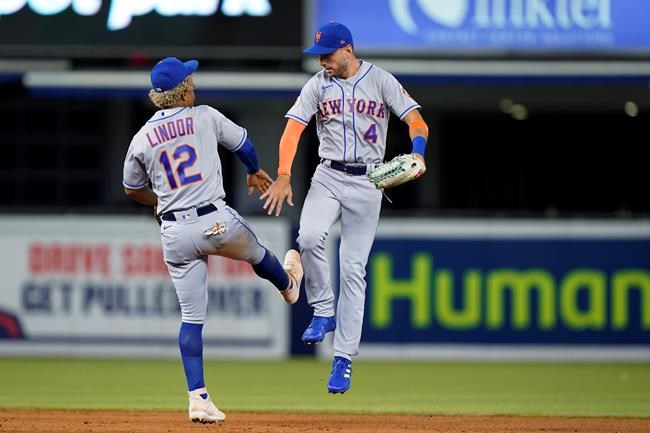 New York Mets shortstop Francisco Lindor (12) and center fielder Albert Almora Jr. (4) celebrate after the Mets defeated the Miami Marlins 9-4 in a baseball game Tuesday, Sept. 7, 2021, in Miami. (AP Photo/Wilfredo Lee)