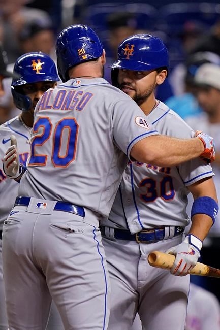 New York Mets' Pete Alonso (20) is congratulated by Michael Conforto (30) after Alonso hit a home run, scoring Francisco Lindor, left rear, during the first inning of a baseball game against the Miami Marlins, Tuesday, Sept. 7, 2021, in Miami. (AP Photo/Wilfredo Lee)
