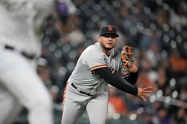 San Francisco Giants relief pitcher Kevin Castro throws to first base to retire Colorado Rockies' Joshua Fuentes during the ninth inning of a baseball game Tuesday, Sept. 7, 2021, in Denver. The Giants won 12-3. (AP Photo/David Zalubowski)