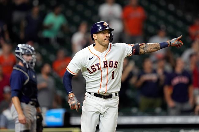 Houston Astros' Carlos Correa (1) celebrates after hitting a game-winning RBI ground-rule double against the Seattle Mariners during the 10th inning of a baseball game Tuesday, Sept. 7, 2021, in Houston. The Astros won 5-4 in 10 innings. (AP Photo/David J. Phillip)