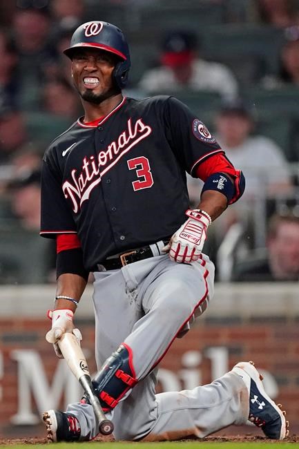 Washington Nationals' Alcides Escobar reacts after fouling a ball off his foot during the seventh inning of the team's baseball game against the Atlanta Braves on Tuesday, Sept. 7, 2021, in Atlanta. (AP Photo/John Bazemore)
