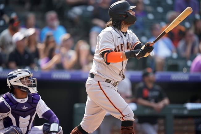 San Francisco Giants' Brandon Crawford watches his three-run home run off Colorado Rockies starting pitcher Jon Gray during the sixth inning of a baseball game Wednesday, Sept. 8, 2021, in Denver. (AP Photo/David Zalubowski)