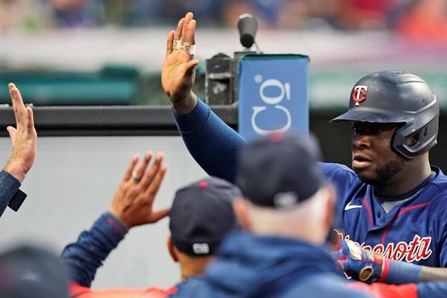 Minnesota Twins' Miguel Sano celebrates with teammates after Sano hit a solo home run during the seventh inning of the team's baseball game against the Cleveland Indians, Wednesday, Sept. 8, 2021, in Cleveland. (AP Photo/Tony Dejak)