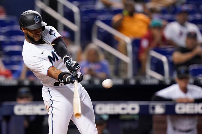 Miami Marlins' Bryan De La Cruz hits a single that scored Jazz Chisholm Jr. in the 10th inning to beat the New York Mets 2-1 in a baseball game Wednesday, Sept. 8, 2021, in Miami. (AP Photo/Wilfredo Lee)