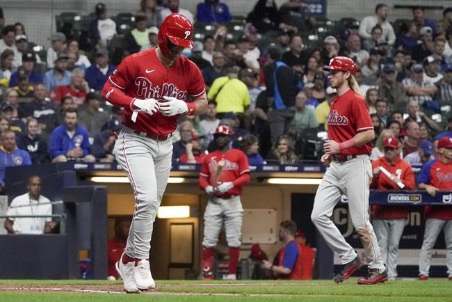 Philadelphia Phillies' Bryce Harper heads to first after walking with bases loaded during the third inning of a baseball game against the Milwaukee Brewers Wednesday, Sept. 8, 2021, in Milwaukee. (AP Photo/Morry Gash)