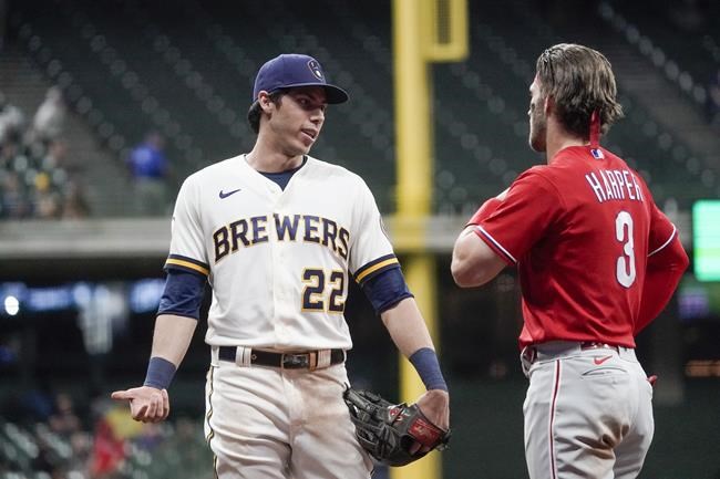 Milwaukee Brewers' Christian Yelich talks to Philadelphia Phillies' Bryce Harper during the eighth inning of a baseball game Wednesday, Sept. 8, 2021, in Milwaukee. (AP Photo/Morry Gash)