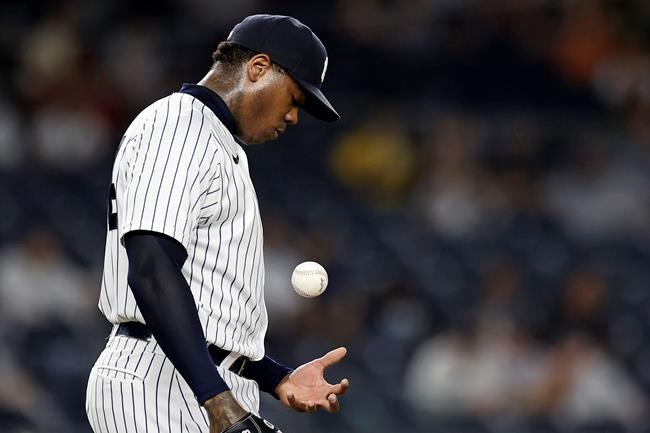 New York Yankees pitcher Aroldis Chapman tosses the ball as he waits to be taken out of the baseball game against the Toronto Blue Jays during the ninth inning Wednesday, Sept. 8, 2021, in New York. The Blue Jays won 6-3. (AP Photo/Adam Hunger)
