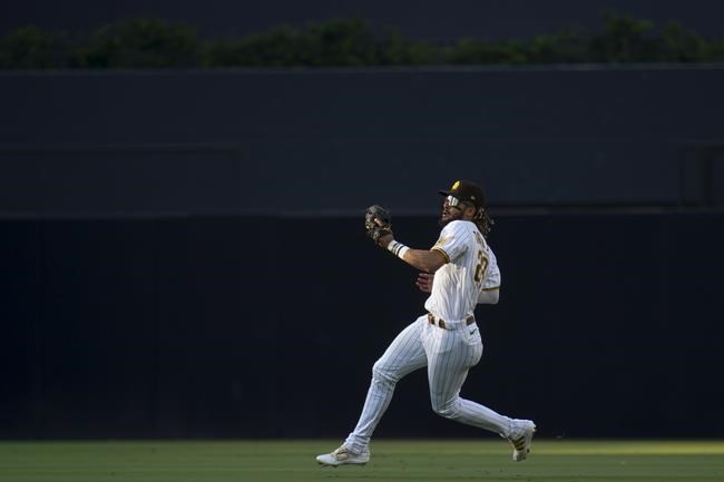 San Diego Padres right fielder Fernando Tatis Jr. gets ready to throw to home after making the catch on a ball hit by Max Stassi, to complete a double play with the out on Jared Walsh during the second inning of a baseball game Wednesday, Sept. 8, 2021, in San Diego. (AP Photo/Gregory Bull)