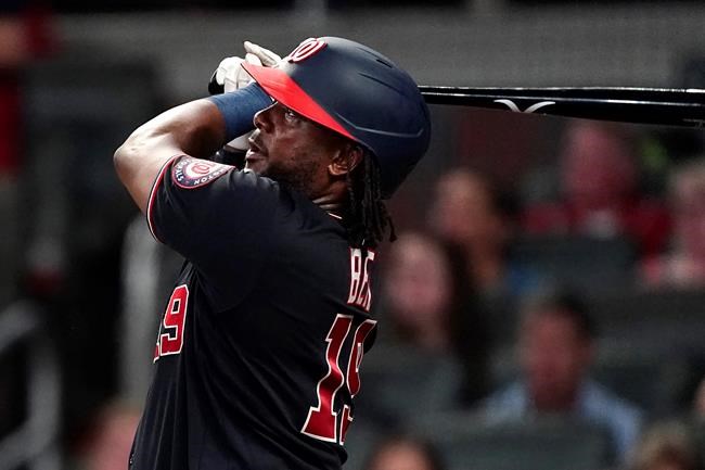 Washington Nationals first baseman Josh Bell (19) follows through on a solo home run in the fourth inning of a baseball game against the Atlanta Braves Wednesday, Sept. 8, 2021, in Atlanta. (AP Photo/John Bazemore)