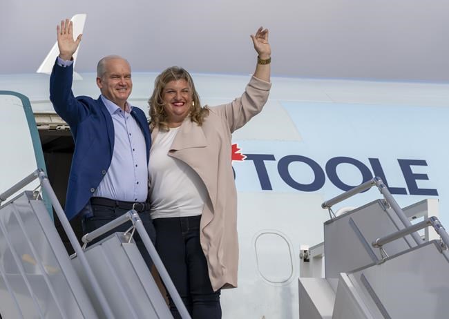 Conservative Leader Erin O'Toole and his wife Rebecca wave from the steps of the airplane prior to departing Ottawa on Friday, September 10, 2021. Canadians will vote in a federal election Sept. 20th. THE CANADIAN PRESS/Frank Gunn