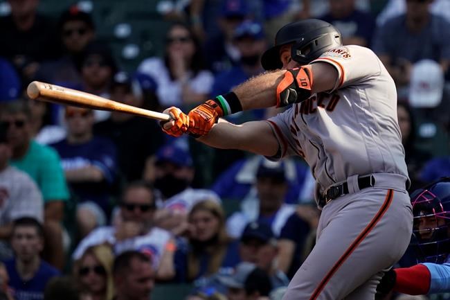 San Francisco Giants' Evan Longoria hits a sacrifice fly during the eighth inning of a baseball game against the Chicago Cubs in Chicago, Friday, Sept. 10, 2021. (AP Photo/Nam Y. Huh)
