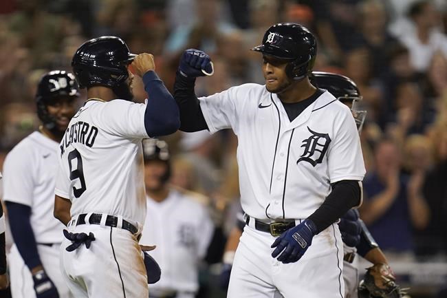 Detroit Tigers' Jonathan Schoop celebrates with Willi Castro (9) after hitting a grand slam against the Tampa Bay Rays in the seventh inning of a baseball game in Detroit, Friday, Sept. 10, 2021. (AP Photo/Paul Sancya)