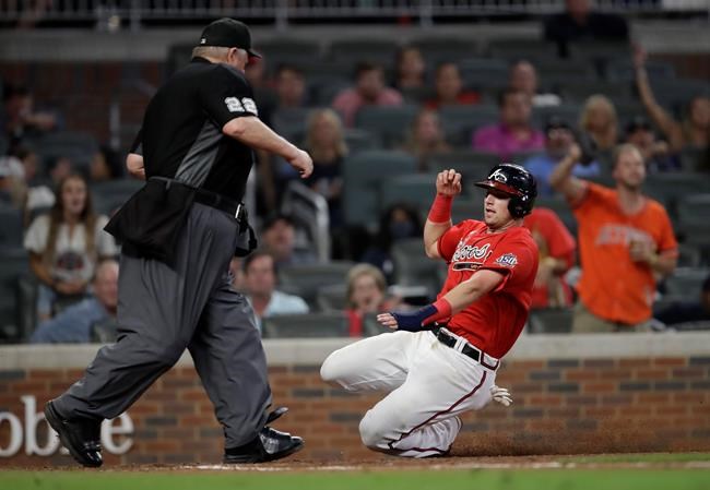 Atlanta Braves' Austin Riley slides to score against the Miami Marlins during the eighth inning of a baseball game Friday, Sept. 10, 2021, in Atlanta. (AP Photo/Ben Margot)