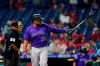 Colorado Rockies' Elias Diaz follows through after hitting a grand slam of Philadelphia Phillies pitcher JD Hammer during the ninth inning of a baseball game, Friday, Sept. 10, 2021, in Philadelphia. (AP Photo/Matt Slocum)