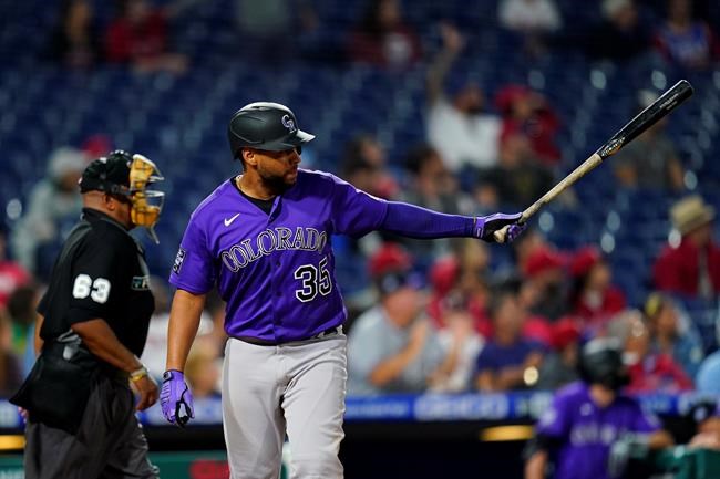 Colorado Rockies' Elias Diaz follows through after hitting a grand slam of Philadelphia Phillies pitcher JD Hammer during the ninth inning of a baseball game, Friday, Sept. 10, 2021, in Philadelphia. (AP Photo/Matt Slocum)