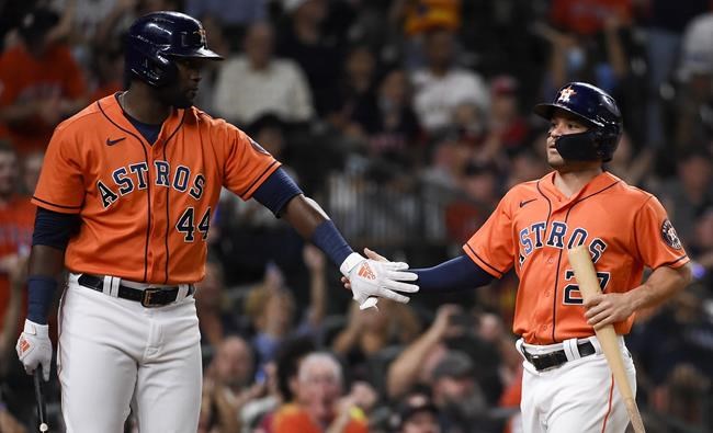 Houston Astros' Jose Altuve, right, celebrates with teammate Yordan Alvarez after scoring a run during the third inning of a baseball game against the Los Angeles Angels, Friday, Sept. 10, 2021, in Houston. (AP Photo/Eric Christian Smith)