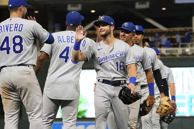Kansas City Royals' Andrew Benintendi (16) goes through the celebration line after the Royals defeated the Minnesota Twins 6-4 in 11 innings in a baseball game Friday, Sept. 10, 2021, in Minneapolis. Benintendi had a two-run homer in the 11th inning and a three-run homer in the first inning. (AP Photo/Jim Mone)