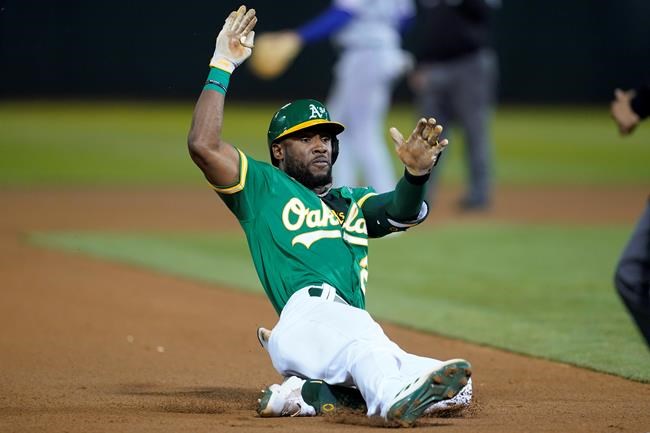 Oakland Athletics' Starling Marte slides into third base with an RBI triple against the Texas Rangers during the fourth inning of a baseball game in Oakland, Calif., Friday, Sept. 10, 2021. (AP Photo/Jeff Chiu)