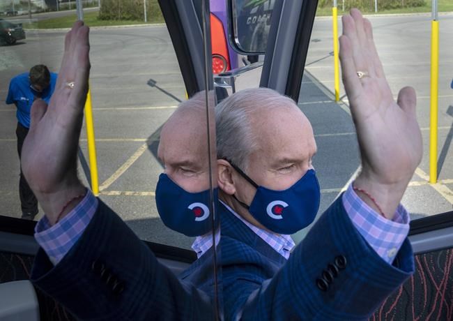 Conservative Leader Erin O'Toole waves as he gets off his bus at a campaign announcement in Whitby, Ont., Saturday, Sept. 11, 2021. Canadians will vote in a federal election Sept. 20th. THE CANADIAN PRESS/Frank Gunn