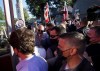 A man, top right, throws gravel at Liberal leader Justin Trudeau, left, as the RCMP security detail provide protection, while protesters shout at a local microbrewery during the Canadian federal election campaign in London Ont., Monday, Sept. 6, 2021. London police say 25-year-old Shane Marshall of St. Thomas, Ont., is now facing one count of assault with a weapon after throwing gravel at the Liberal Leader. THE CANADIAN PRESS/Nathan Denette