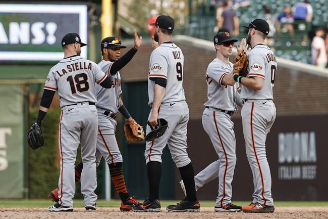 San Francisco Giants players celebrate the team's 15-4 win over the Chicago Cubs in a baseball game, Saturday, Sept. 11, 2021, in Chicago. (AP Photo/Kamil Krzaczynski)