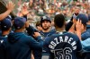 Tampa Bay Rays' Kevin Kiermaier, middle, is congratulated after scoring a run against the Detroit Tigers duirng the second inning of a baseball game Saturday, Sept. 11, 2021, in Detroit. (AP Photo/Jose Juarez)
