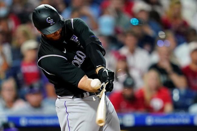 Colorado Rockies' C.J. Cron breaks his bat on a line out against Philadelphia Phillies pitcher Zack Wheeler during the sixth inning of a baseball game, Saturday, Sept. 11, 2021, in Philadelphia. (AP Photo/Matt Slocum)