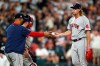 Boston Red Sox manager Alex Cora, left, takes the ball from relief pitcher Garrett Richards, right, during the fourth inning of a baseball game against the Chicago White Sox, Saturday, Sept. 11, 2021, in Chicago. (AP Photo/Jeff Haynes)