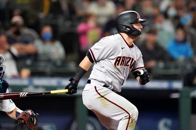 Arizona Diamondbacks' Daulton Varsho watches his two-run double against the Seattle Mariners during the sixth inning of a baseball game Saturday, Sept. 11, 2021, in Seattle. (AP Photo/Elaine Thompson)