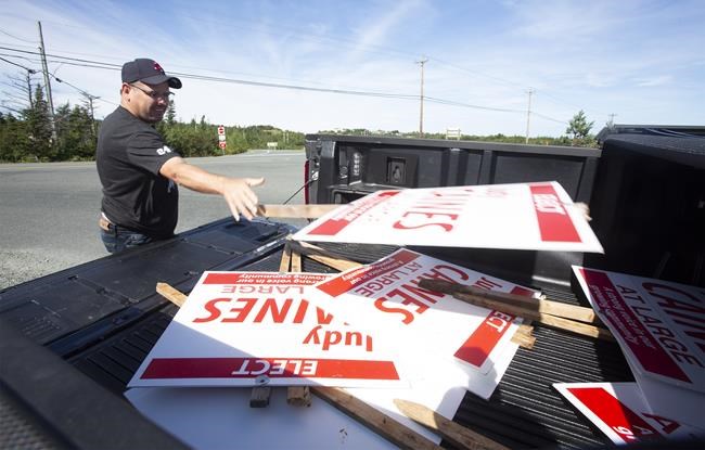 Murray Caines removes his wife's municipal election signs before the arrival of Hurricane Larry, in Conception Bay South, N.L., Sept. 10, 2021. THE CANADIAN PRESS/Paul Daly