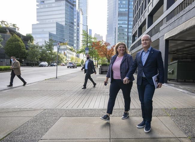 Conservative Leader Erin O'Toole and his wife Rebecca walk to a campaign announcement in Vancouver on Sunday, Sept. 11, 2021. Canadians will vote in a federal election Sept. 20. THE CANADIAN PRESS/Frank Gunn
