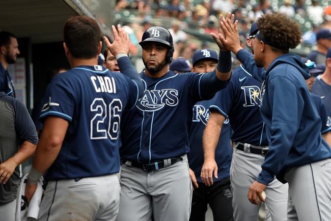 Tampa Bay Rays designated hitter Nelson Cruz, center, is congratulated by teammates after scoring a run on a ground out by Kevin Kiermaier off Detroit Tigers relief pitcher Gregory Soto in the tenth inning of a baseball game, Sunday, Sept. 12, 2021, in Detroit. (AP Photo/Jose Juarez)