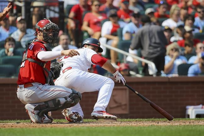 St. Louis Cardinals' Nolan Arenado, right, gets back up after falling onto Cincinnati Reds catcher Tyler Stephenson while avoiding an inside pitch during the fourth inning of a baseball game Sunday, Sept. 12, 2021, in St. Louis. (AP Photo/Scott Kane)