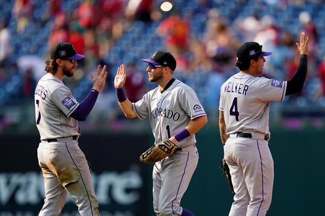Colorado Rockies' Brendan Rodgers, from left, Garrett Hampson and Colton Welker celebrate after a baseball game against the Philadelphia Phillies, Sunday, Sept. 12, 2021, in Philadelphia. (AP Photo/Matt Slocum)