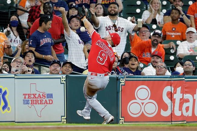 Los Angeles Angels third baseman Jack Mayfield (9) misses a catch at the net on the foul ball hit by Houston Astros' Kyle Tucker during the third inning of a baseball game Sunday, Sept. 12, 2021, in Houston. (AP Photo/Michael Wyke)