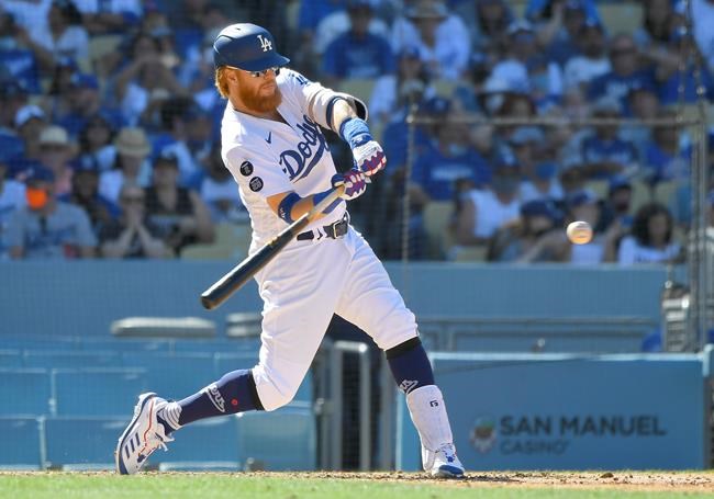 Los Angeles Dodgers' Justin Turner hits a three-run home run against the San Diego Padres in the seventh inning in a baseball game Sunday, Sept. 12, 2021, in Los Angeles, Calif. (AP Photo/John McCoy)