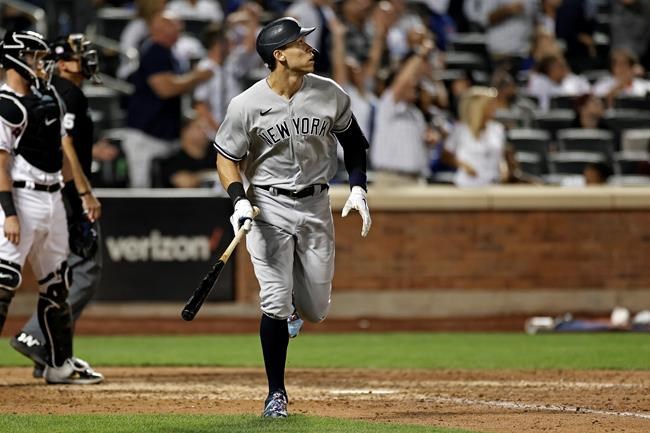 New York Yankees' Aaron Judge watches his two-run home run against the New York Mets during the eighth inning of a baseball game on Saturday, Sept. 11, 2021, in New York. (AP Photo/Adam Hunger)