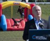 Children play on a bouncy castle as Conservative party Leader Erin O'Toole delivers remarks at a campaign stop in Carp, Ont., on Monday, Sept. 13, 2021. THE CANADIAN PRESS/Adrian Wyld