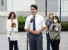 Liberal Leader Justin Trudeau answers questions as his son Hadrien and wife Sophie Grégoire Trudeau, left, and BC Nurses, right, stand to his side at a campaign stop in Vancouver, B.C., on Monday, Sept. 13, 2021. THE CANADIAN PRESS/Sean Kilpatrick