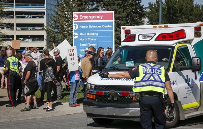Protesters gather at the Foothills Hospital to oppose COVID-19 related public health measures in Calgary, Monday, Sept. 13, 2021. THE CANADIAN PRESS/Jeff McIntosh