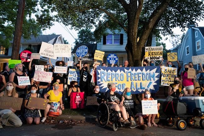 Protesters gather outside the home of Supreme Court Justice Brett Kavanaugh, Monday, Sept. 13, 2021, in Chevy Chase, Md., after a high-profile decision earlier this month in which the court by 5-4 vote declined to step in to stop a Texas law banning most abortions from going into effect, prompting outrage from abortion rights groups and President Joe Biden. THE CANADIAN PRESS/AP-Jose Luis Magana