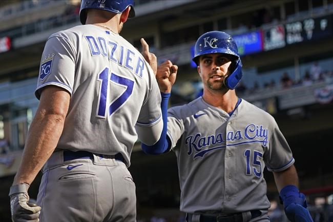Kansas City Royals Whit Merrifield (15) fist-bumps Hunter Dozier after Merrifield scored on a Andrew Benintendi sacrifice fly off Minnesota Twins pitcher Juan Minaya in the ninth inning of a baseball game, Sunday, Sept. 12, 2021, in Minneapolis. The Royals won 5-3. (AP Photo/Jim Mone)