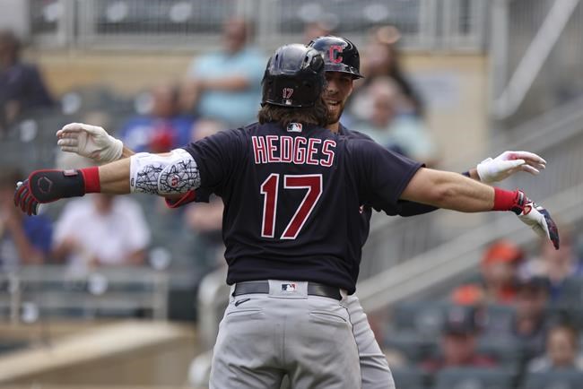 Cleveland Indians' Austin Hedges (17) celebrates with teammate Bradley Zimmer (4) after Zimmer hit a home run against the Minnesota Twins, during the fifth inning of the first baseball game of a doubleheader Tuesday, Sept. 14, 2021, in Minneapolis. Cleveland won 3-1. (AP Photo/Stacy Bengs)