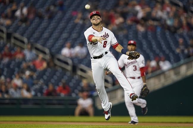 Washington Nationals third baseman Carter Kieboom throws out Miami Marlins' Lewis Brinson at first base during the first inning of a baseball game at Nationals Park, Tuesday, Sept. 14, 2021, in Washington. (AP Photo/Alex Brandon)