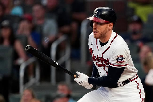 Atlanta Braves first baseman Freddie Freeman (5) drives in a run with a base hit in the first inning of a baseball game against the Colorado Rockies Tuesday, Sept. 14, 2021, in Atlanta. (AP Photo/John Bazemore)