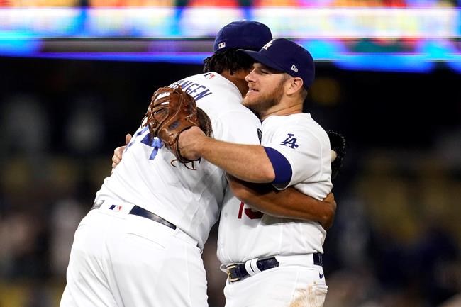 Los Angeles Dodgers relief pitcher Kenley Jansen, left, hugs Max Muncy after the Dodgers' 8-4 win over the Arizona Diamondbacks in a baseball game Tuesday, Sept. 14, 2021, in Los Angeles. (AP Photo/Marcio Jose Sanchez)