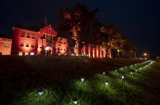 Two hundred and fifteen lights are placed on the lawn outside the Residential School in Kamloops, B.C., on June, 13, 2021. A prime-time special in honour of residential school survivors will air on APTN and CBC/Radio-Canada on the inaugural National Day for Truth and Reconciliation on Sept. 30. Producers say the one-hour, commercial-free