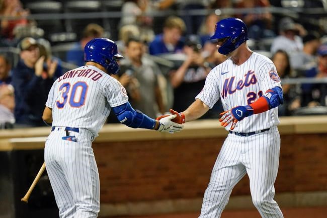 New York Mets' Michael Conforto, left, celebrates with New York Mets' Pete Alonso, wearing Pittsburgh Pirates Hall of Fame player Roberto Clemente's No. 21 on Roberto Clemente Day, after Alonso hit a home run during the second inning of a baseball game against the St. Louis Cardinals Wednesday, Sept. 15, 2021, in New York. (AP Photo/Frank Franklin II)